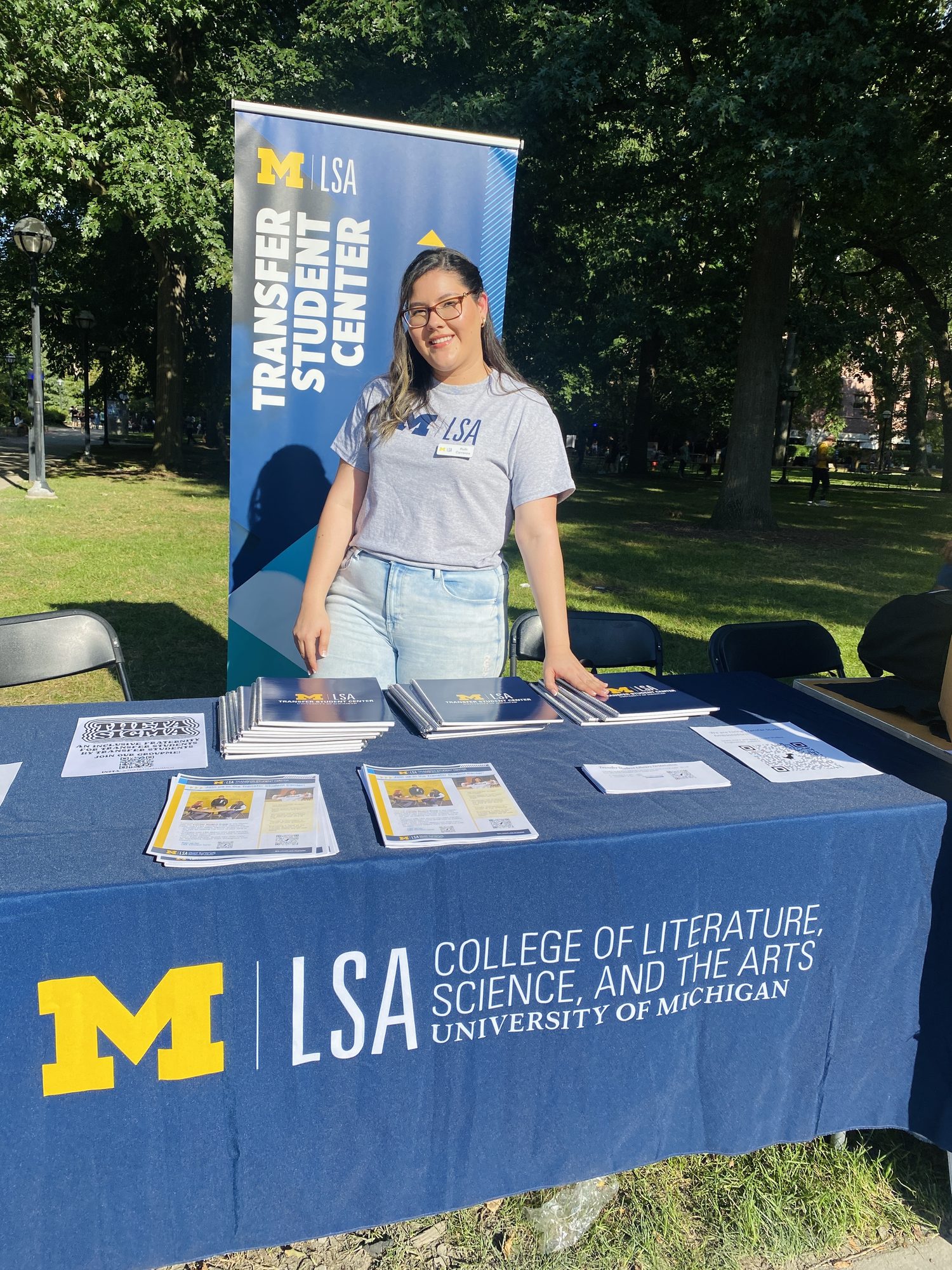 Ruth staffing the LSA Transfer Student Center outreach table on the Diag, handing out transfer student guides.